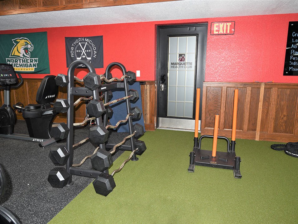 a room with a row of weights and a cart in it