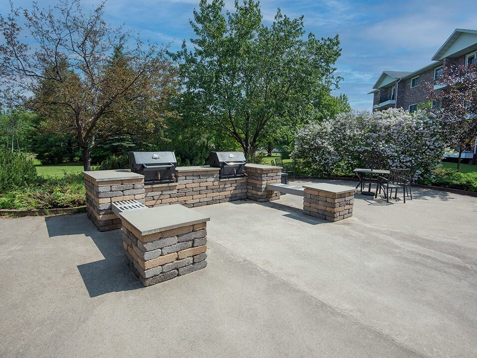the backyard has a large patio with a grill and bbq area