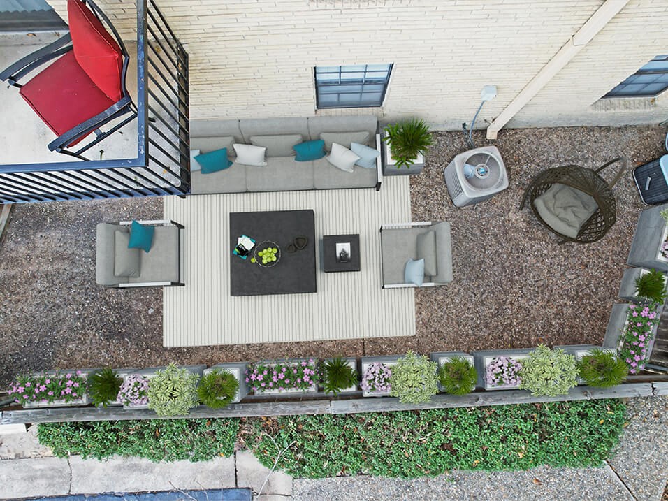 a birds eye view of apartment patio with furniture
