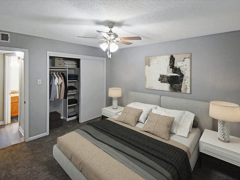 a bedroom with a bed and a ceiling fan