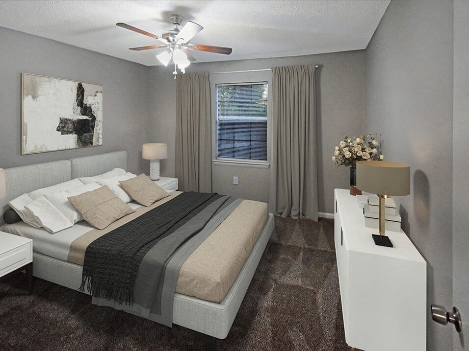 a bedroom with a bed and a ceiling fan