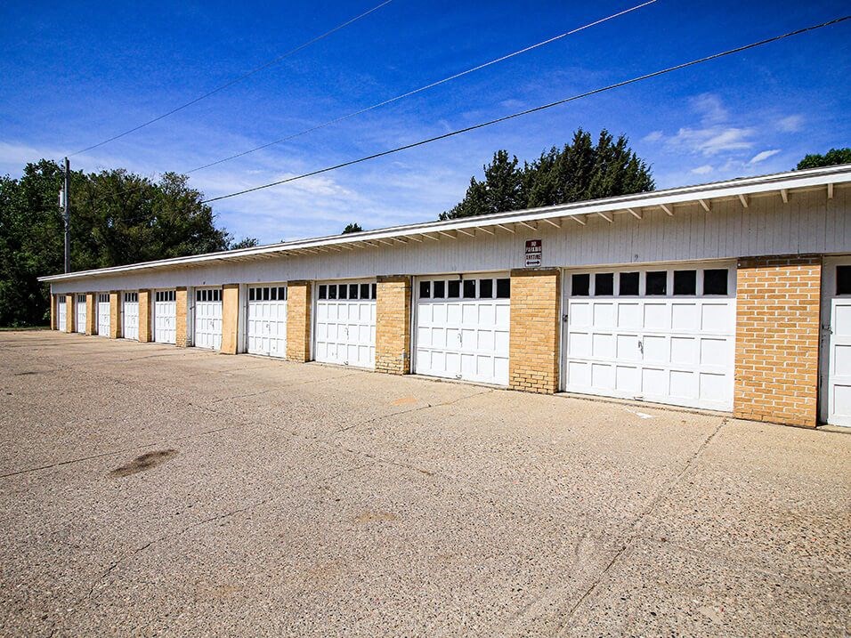 a row of garages with a blue sky in the background