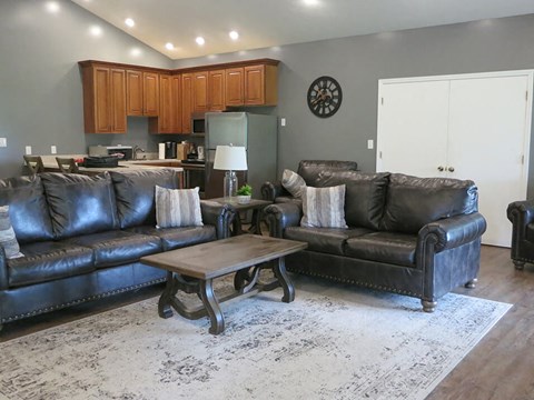 a living room with leather couches and a coffee table