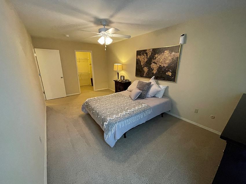 a bedroom with a bed and a ceiling fan - Photo Gallery