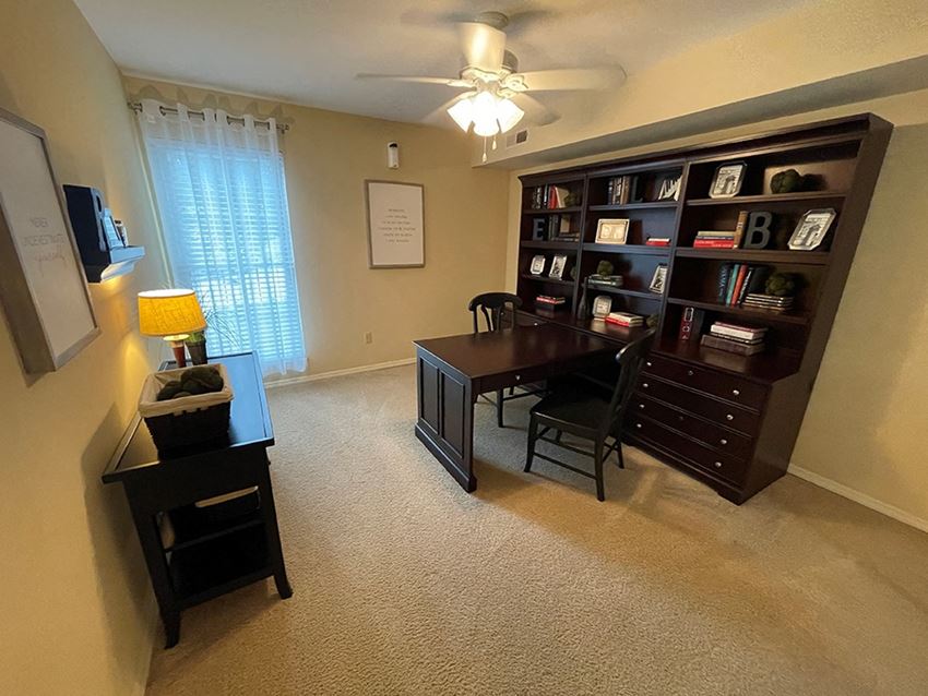 a home office with a desk and a ceiling fan - Photo Gallery