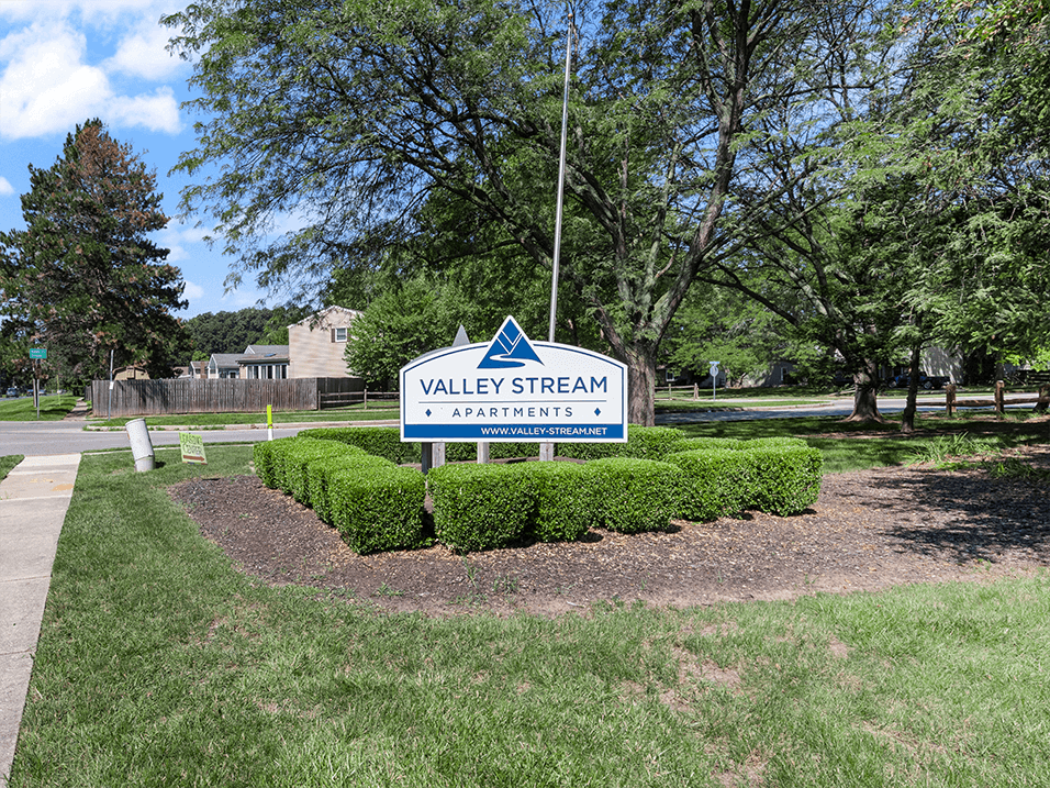 a welcome sign for Valley Stream Apartment community