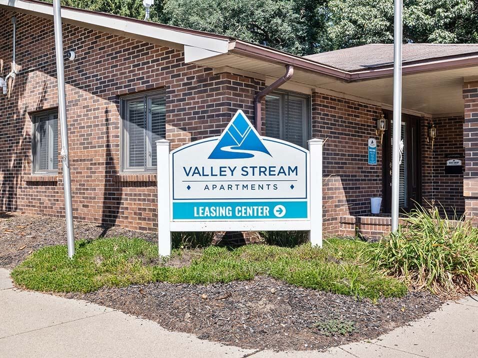 a sign for Valley Stream Apartments leasing office