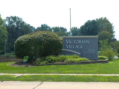 the welcome sign for Victorian Village Townhomes