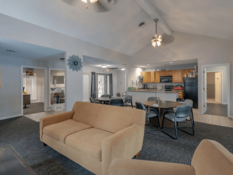 a living room and dining room with a couch and a table