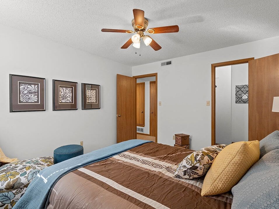 a bedroom with a bed and a wallpaper on the wall