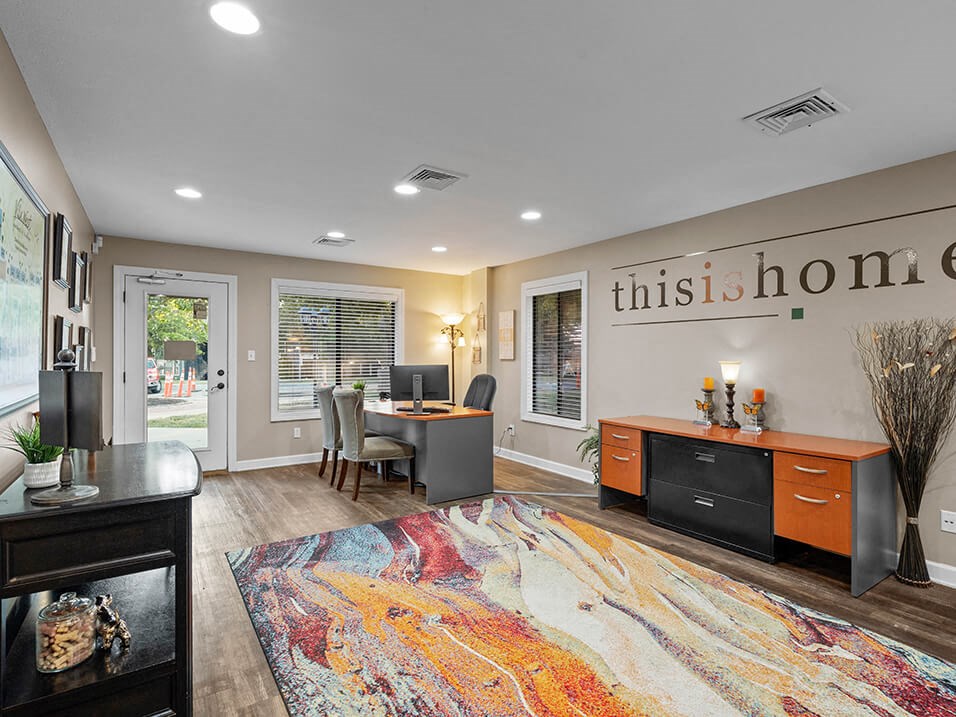 a living room filled with furniture and a rug