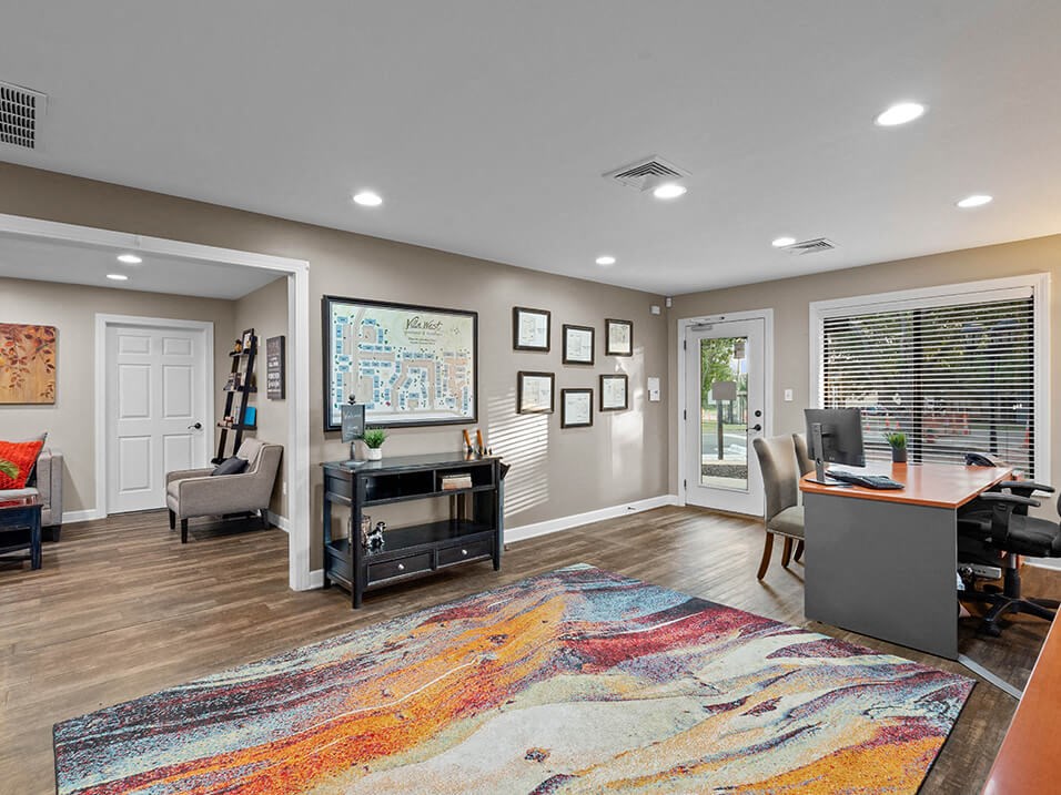 a home office with a desk and a rug
