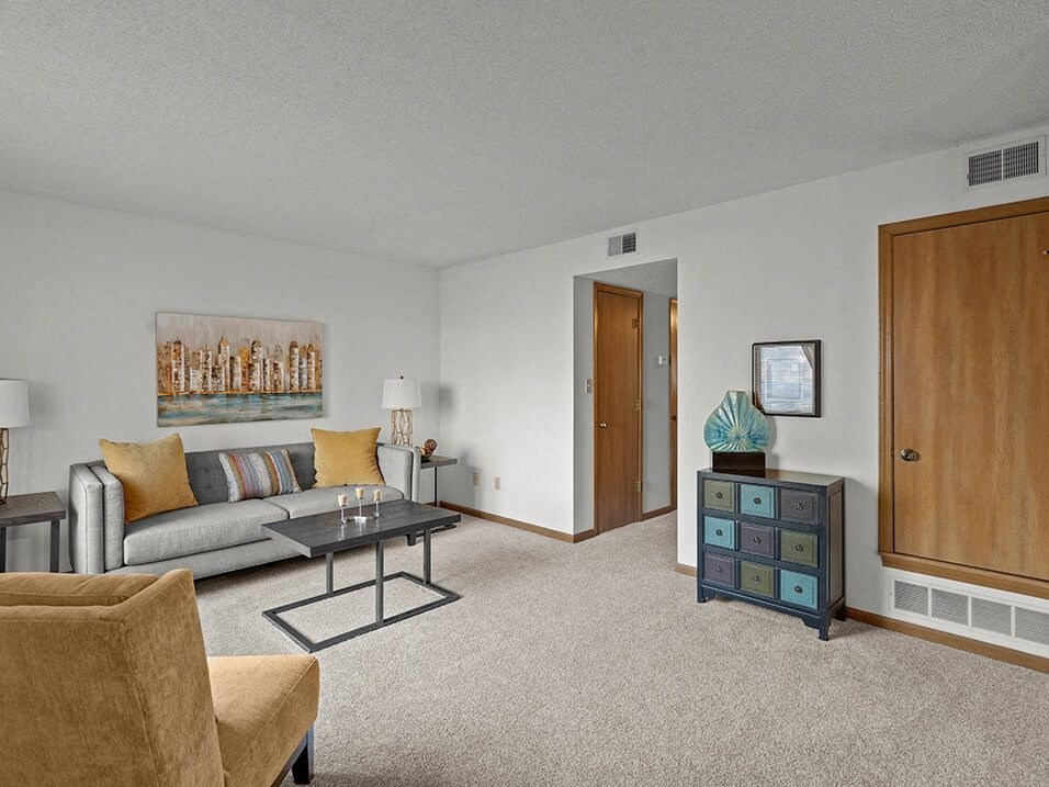 carpeting living room with attached hall way