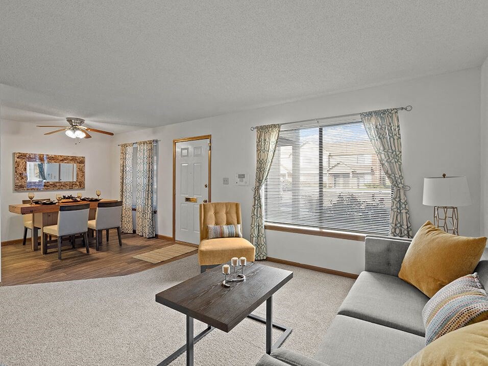 Living room with natural light and a large window with carpeting