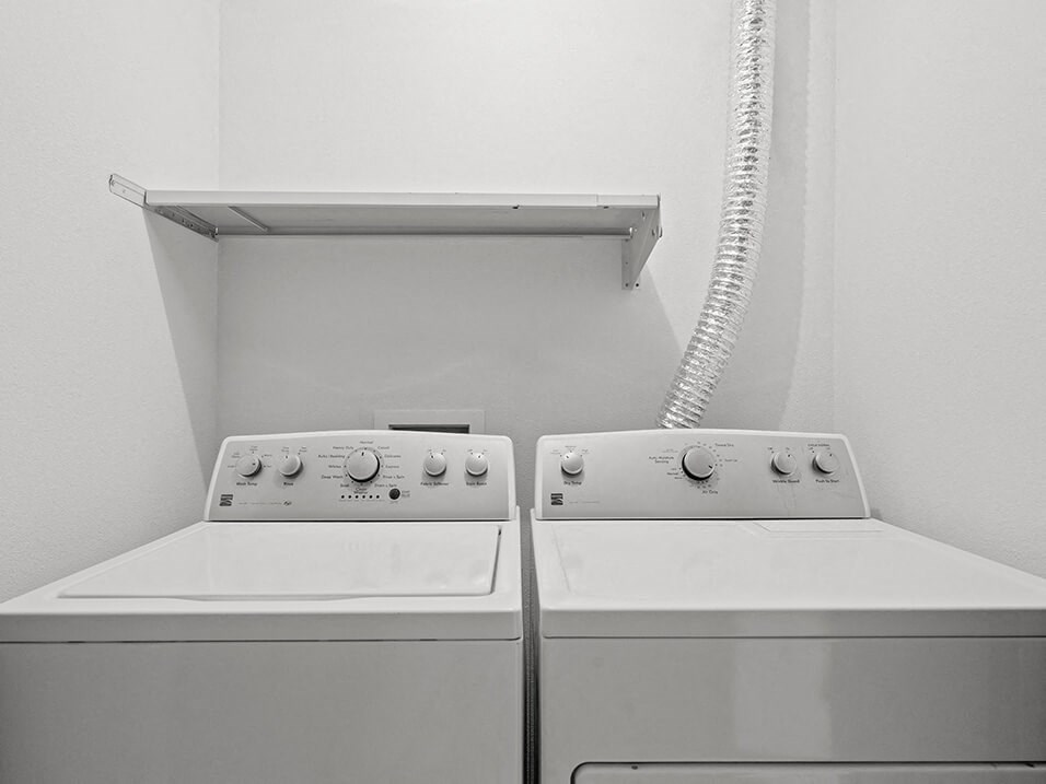 two white washing machines in a white room