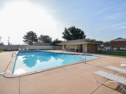 A swimming pool with a building in the background.