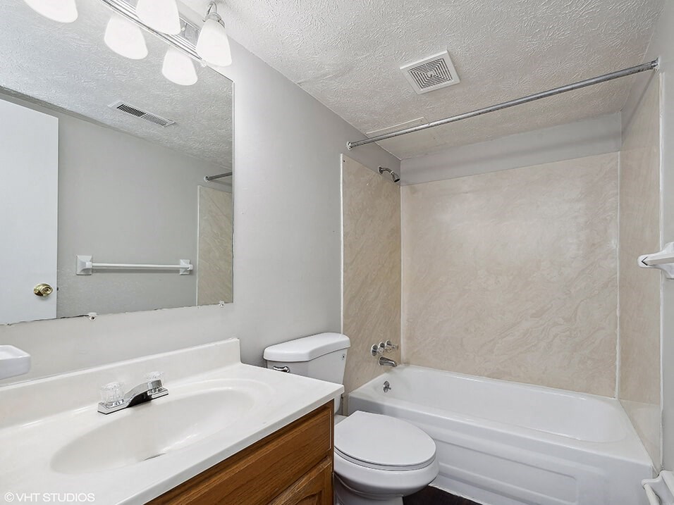 a bathroom with a sink toilet and a tub