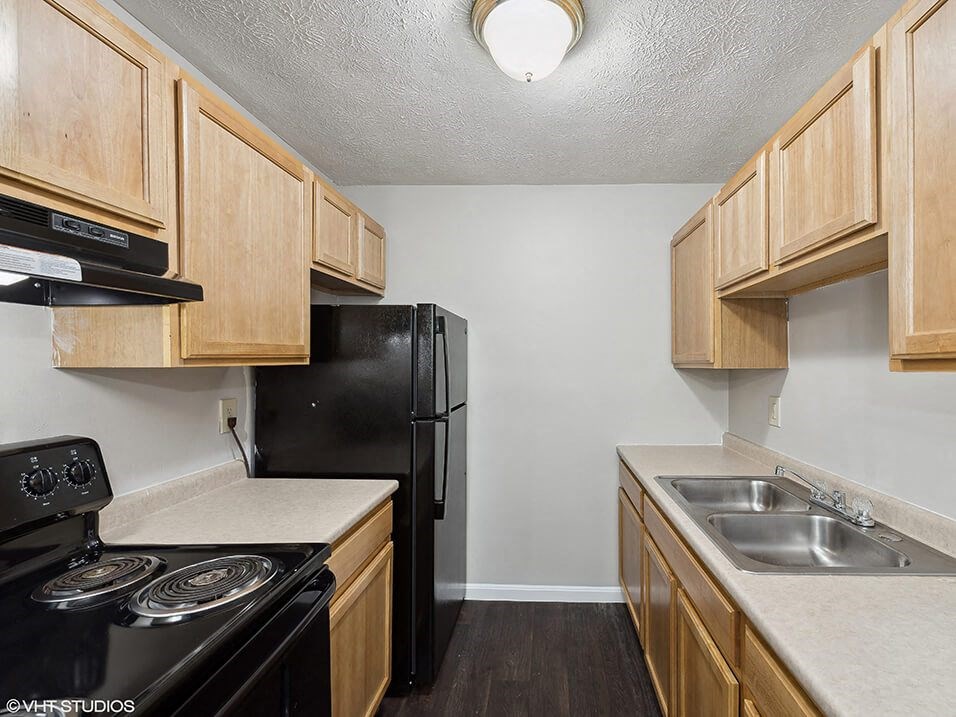 a kitchen with a stove refrigerator and sink