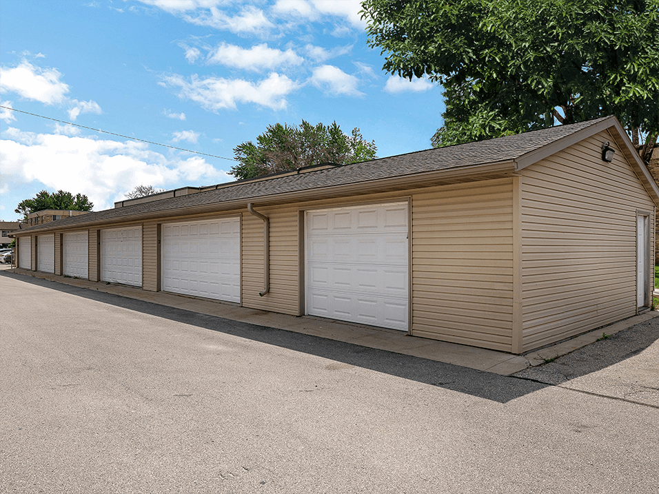 a row of garages with white doors