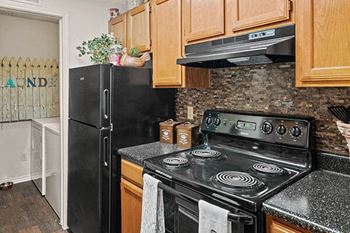 a kitchen with a stove and a refrigerator