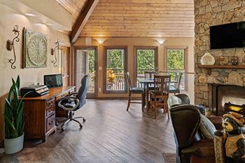 a living room with a fireplace and a table with chairs
