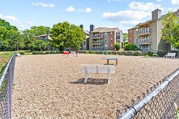 a park with a bench and a picnic table