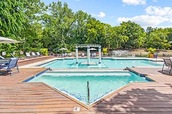 a swimming pool with trees in the background