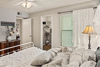 a bedroom with a bed and a lamp in it