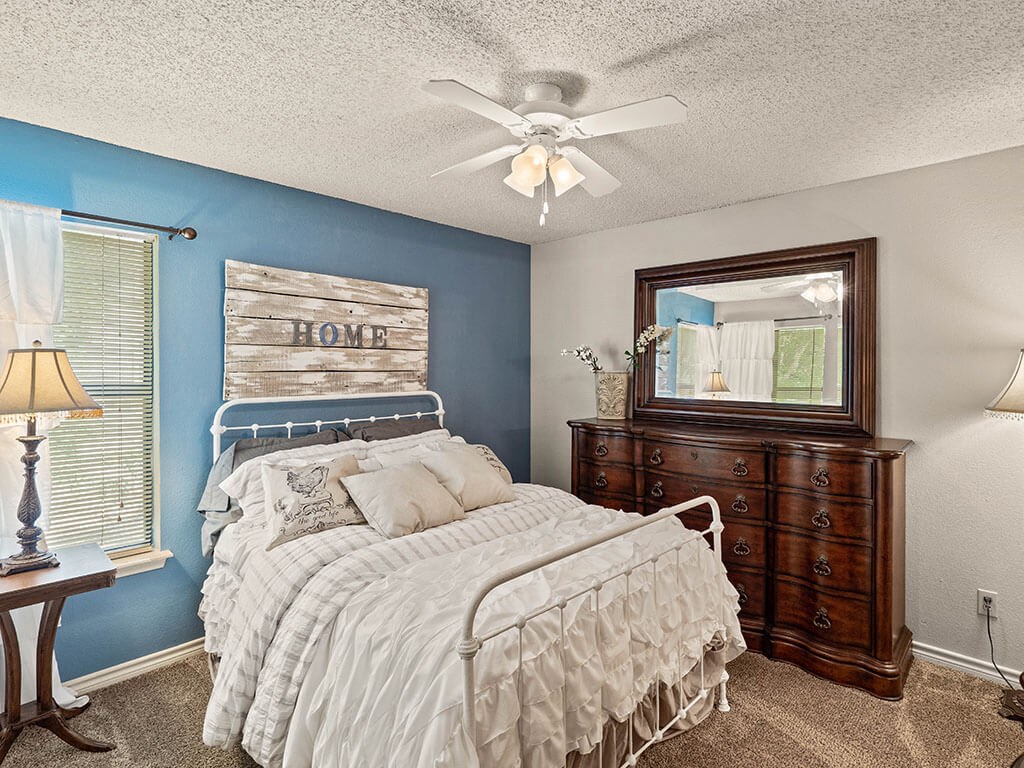 apartment bedroom with a ceiling fan
