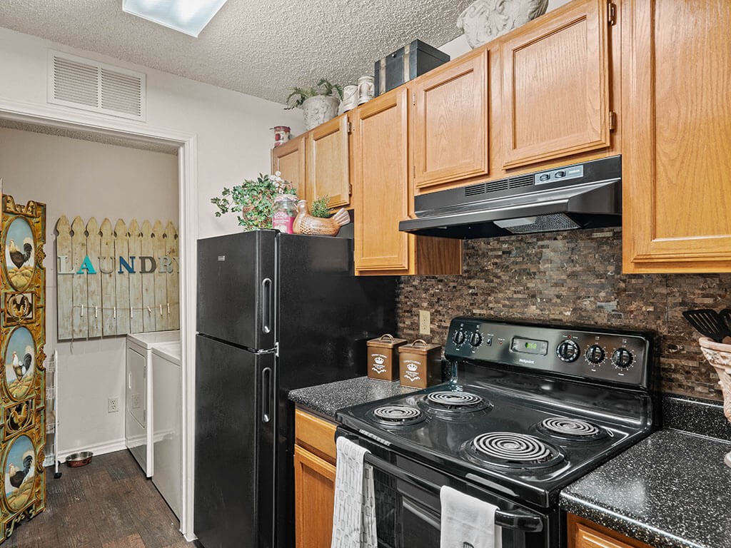 apartment kitchen with a stove and a refrigerator