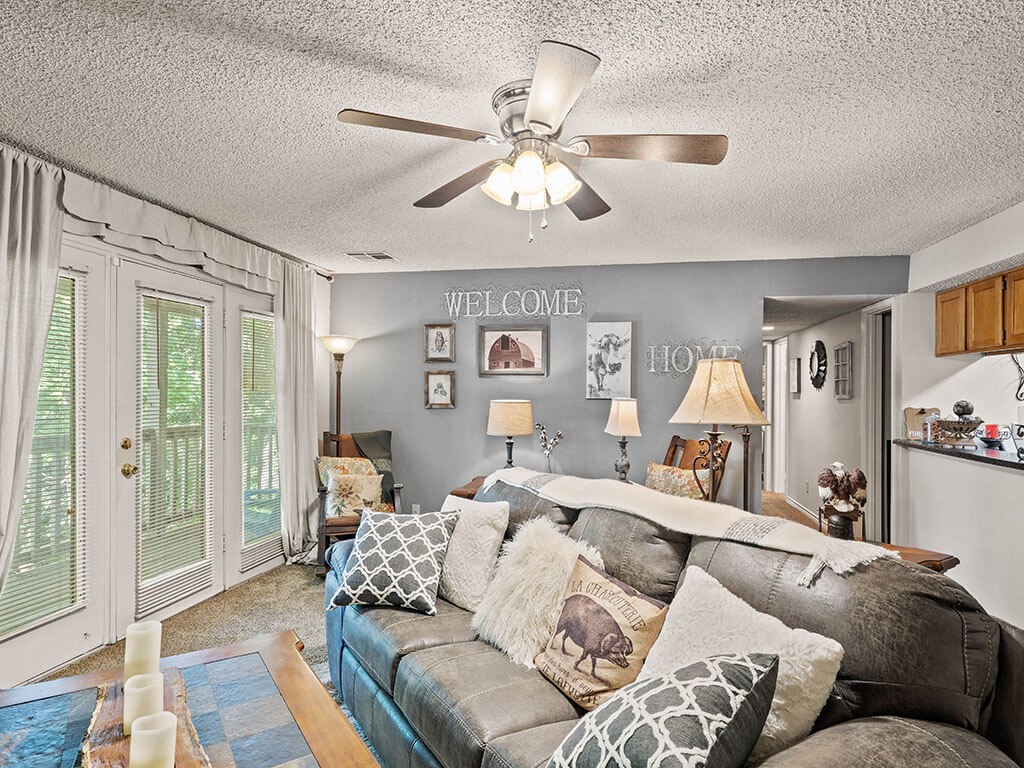 apartment living room with a couch and a ceiling fan