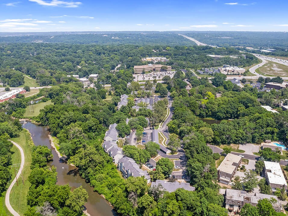 an aerial view of a apartment community and trees
