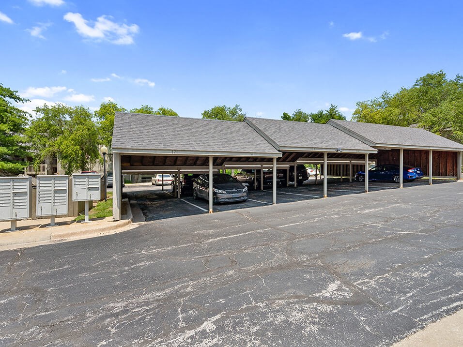 a parking lot with carports at apartment complex
