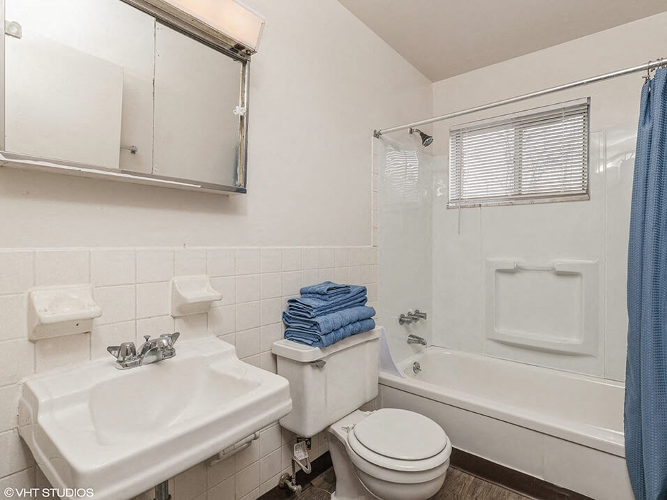 a bathroom with a sink toilet and a tub