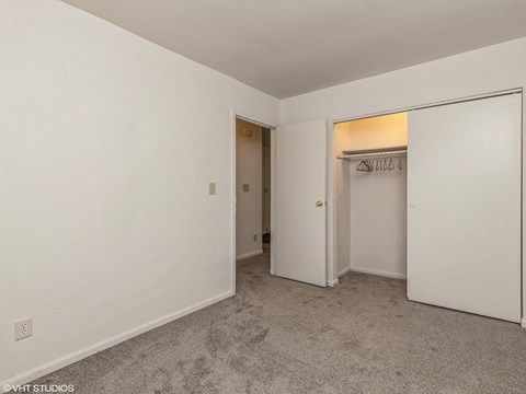 a bedroom with a closet and a door to a closet