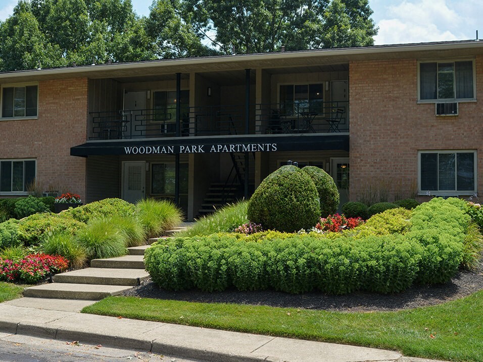 a building with a sign that reads apartments