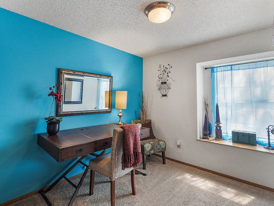 a bedroom with a desk