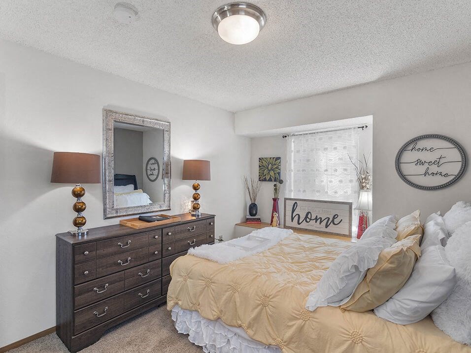 a bedroom with a bed and dresser