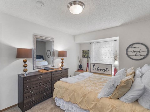 a bedroom with a bed and dresser
