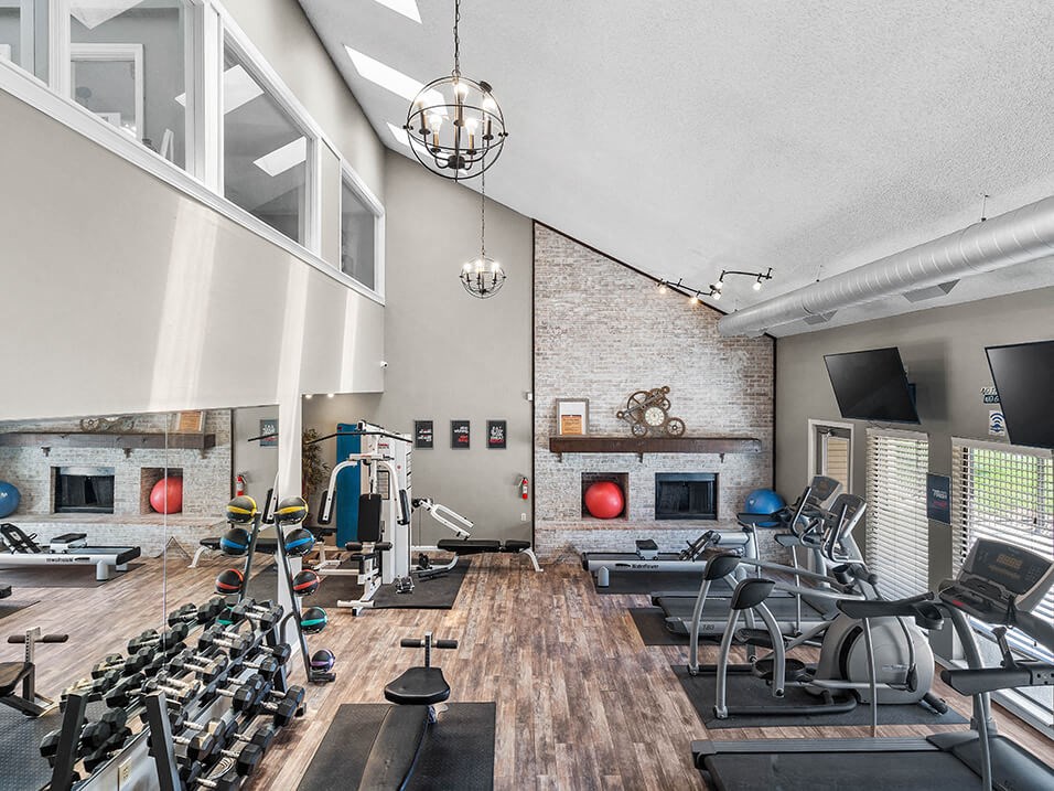gym has plenty of exercise equipment and a large window