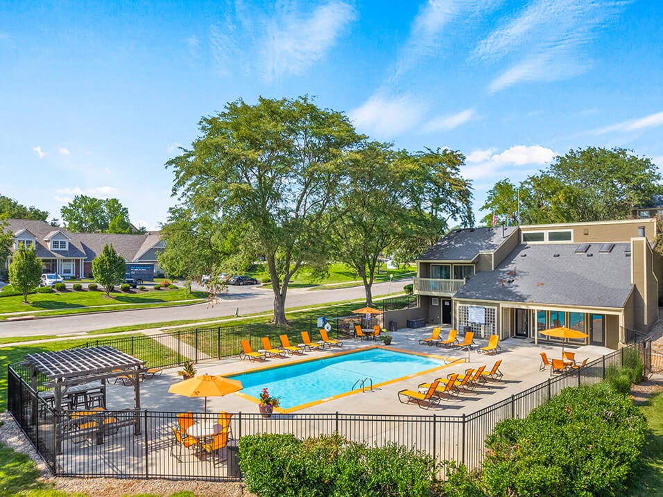 a swimming pool with chairs and umbrellas