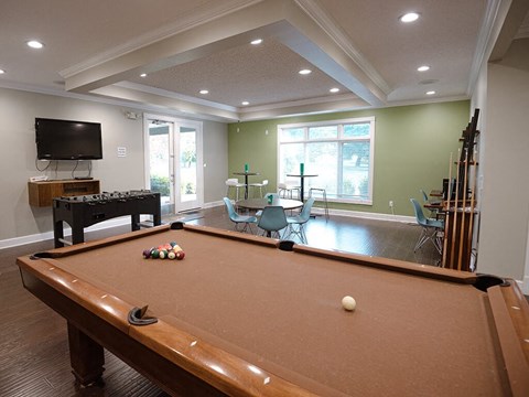 a game room with a pool table and a television