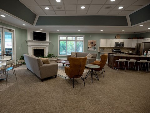 a living room with a table and chairs and a fireplace