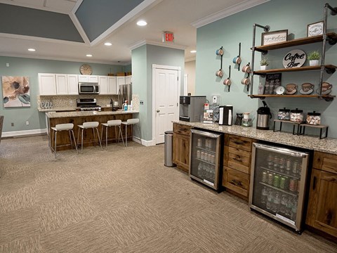a kitchen with a counter and a bar with stools