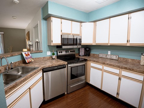 a kitchen with stainless steel appliances and white cabinets
