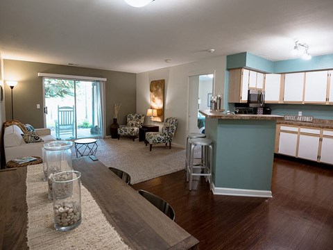 a living room with a kitchen and a table