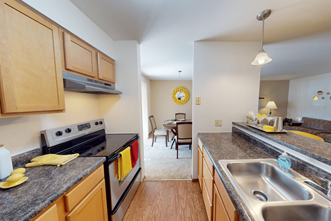 A kitchen with a stove top oven and a sink.