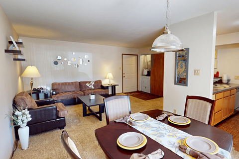 A dining room with a table set for two.