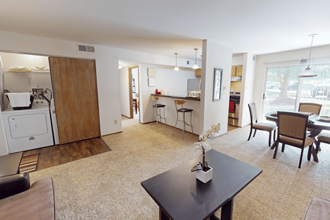 A kitchen area with a dining table and chairs.