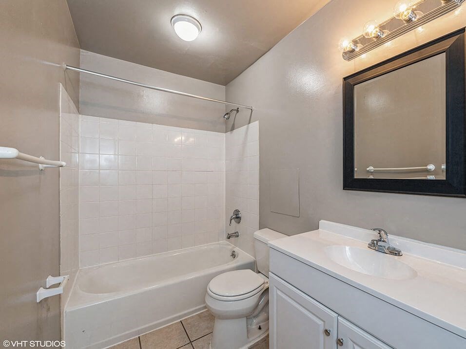 a bathroom with a sink toilet and a bath tub